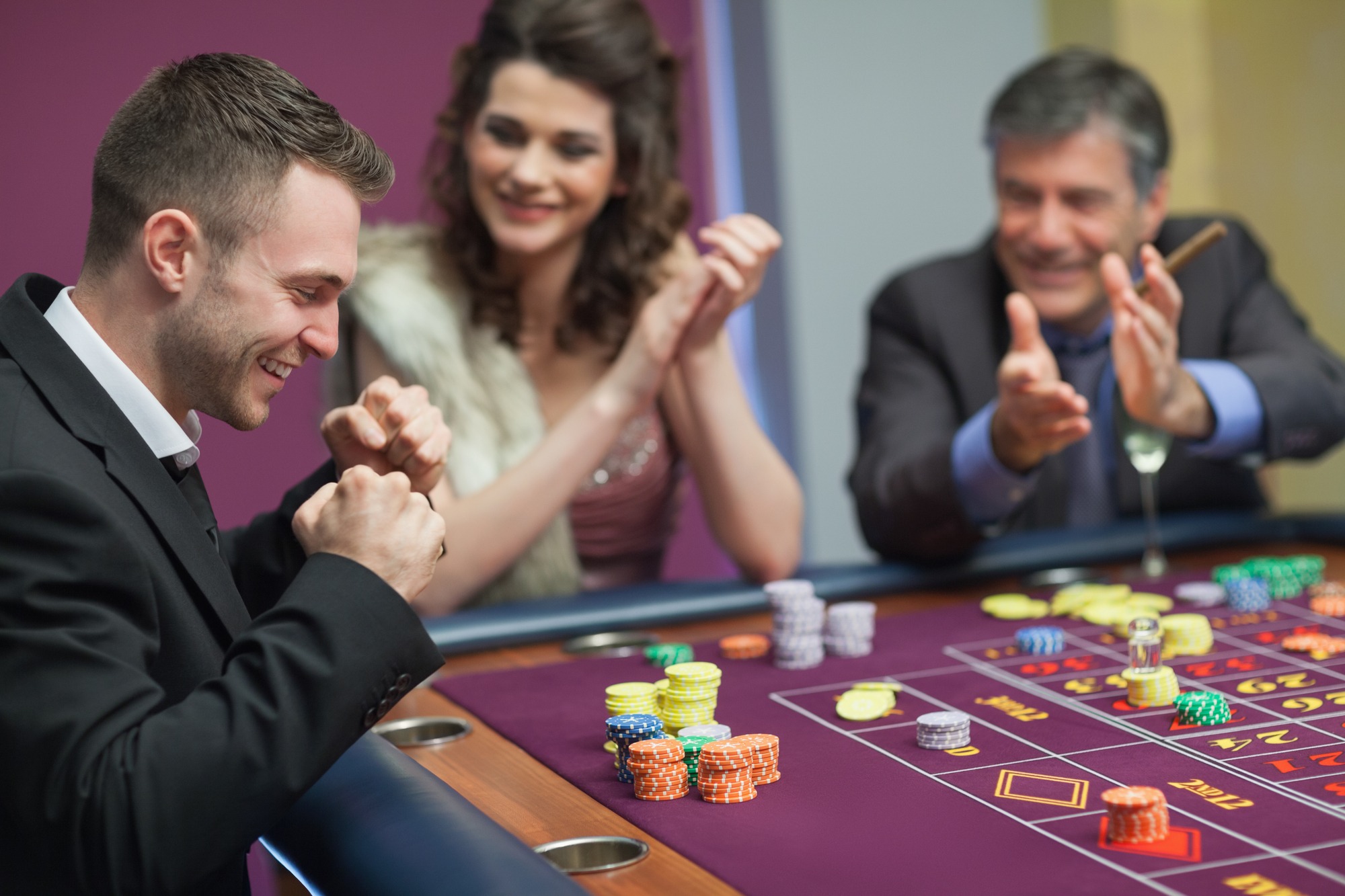 People Cheering Man at Craps Game in Casino